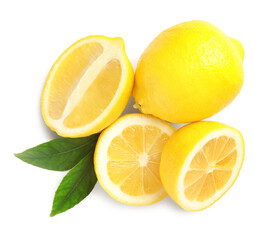 Cut and whole ripe lemons with green leaves on white background, top view