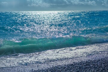 Ocean wave with spray, sea summer. liquid sky