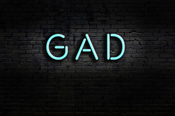 Night view of neon sign on brick wall with inscription gad © iushakovsky