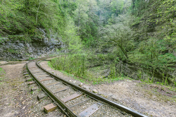 Fototapeta premium Narrow gauge railway in the deep narrow Guam canyon. Western Caucasus.
