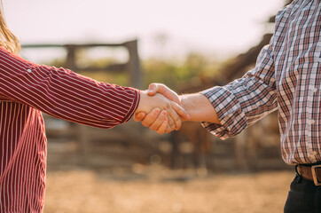 Latino farmers man and woman shaking hands. Farmers closing business