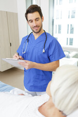 senior woman in a hospital having talking to male doctor