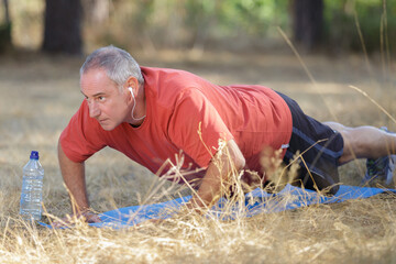 middle age man doing plank exercise