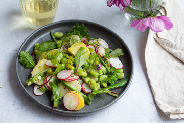 Healthy salad with potato, broad beans and summer salad leaves
