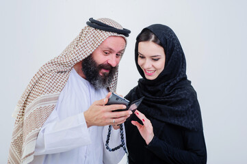 Portrait of Arabic way dressed couple play with mobile phone