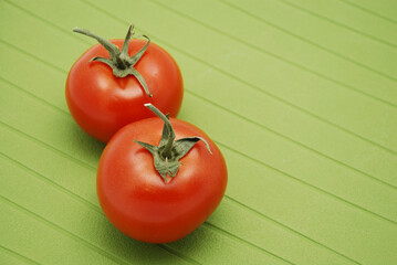 Fresh Tomatoes on green background
