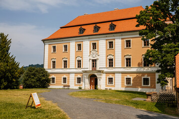 Fototapeta na wymiar Valec, Western Bohemia, Czech Republic, 19 June 2021: Baroque castle front yard with green lawn at sunny summer day