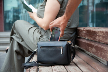 Man steal phone : from females bag. Lady and street thief.