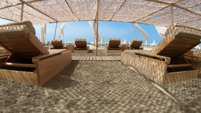 Suumer vacation luxury resort white tent on a sandy beach against the background of blue sunny sky