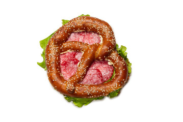 Pretzel with salami and lettuce isolated on a white background.