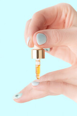 nail care, a girl drips oil with vitamins on her nails