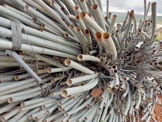 Group of metal arches reused to cover land where organic strawberries are grown.