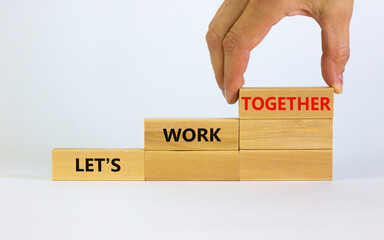 Work together symbol. Wooden blocks with words Let is work together on beautiful white background....
