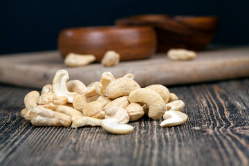 pile of cashew nuts on the table and in a wooden plate while eating