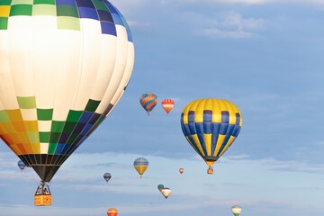 Balloon Festival Mongolfieria, part of a bright multicolored balloon in the air with a blue sky in...