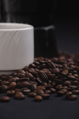 Extreme close-up of coffee beans with coffeemaker on background