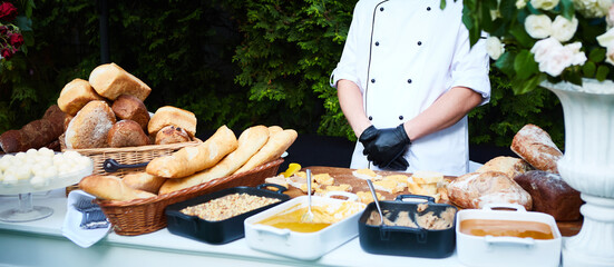 Kitchenware in the line catering buffet food in luxury outdoor restaurant.