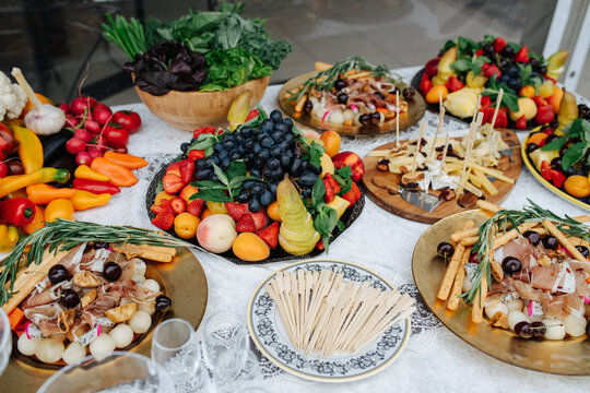High angle image of an abandant table set for event. Large plates full of fruit.