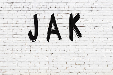 White wall with black paint inscription jak on it © iushakovsky