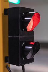 Vertical shot traffic lights closeup turn red when entering or exiting parking lot.