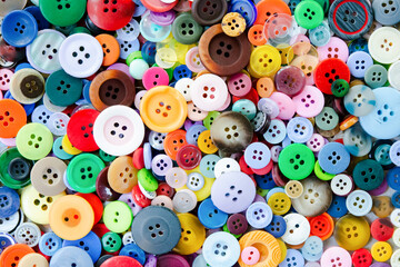 Fototapeta na wymiar Colorful mixed sewing buttons background. Top view