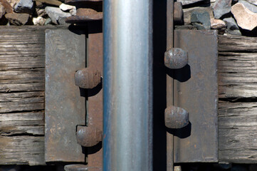 View looking down on a single railroad track rail and tie plate