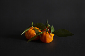 Close-up of group of tangerines on the dark background