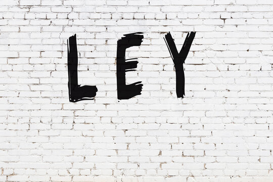 White wall with black paint inscription ley on it