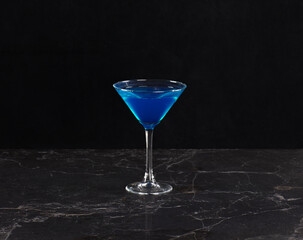 blue curacao cocktail on black background