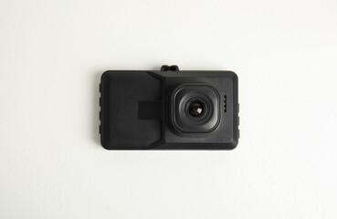 Modern car dashboard camera on white background, top view