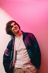 Smiling man in casual clothes posing on pink background