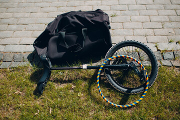 Circus unicycle laying on a green grass © primipil