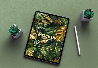 Tablet Mockup on a Sandpaper Dry Green Desk and Trendy Succulents Green Flowers