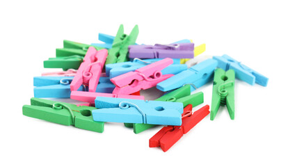 Pile of colorful wooden clothespins on white background