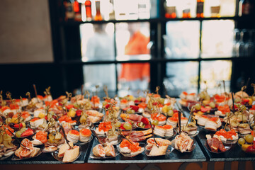 Food catering appetizers snacks on a tray on table.