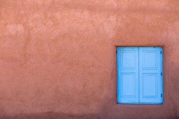 Abstract image of blue window and red adobe wall, Taos, New Mexico