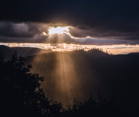 Sunlight rays burst through clouds after storm, Yosemite California