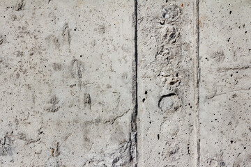 Texture photo of grey colored concrete wall made of blocks.