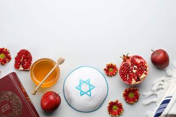 Flat lay composition with Rosh Hashanah holiday attributes on white background. Torah book with...