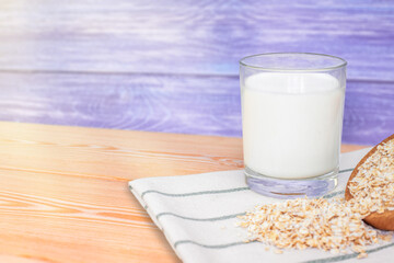 glass of milk and oatmeal on a blue wooden background