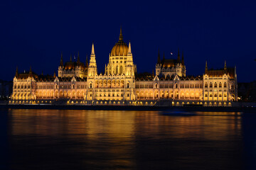 Fototapeta na wymiar Panoramic view of Hungarian Parliament reflecting in Danube river. Night cityscape of Budapest