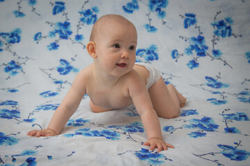 Little baby in a diaper on the bed