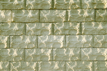 Background of yellow bricks. Wall of yellow bricks. The texture of the wall. Texture of gold decorative tiles in form of brick.