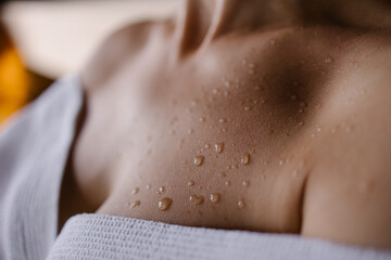 Close-up of a sweat drop in the sauna. Close-up skin after shower. Tanned body. Detox program in the spa concept. hot to sweat Lifestyle Aesthetically - obrazy, fototapety, plakaty