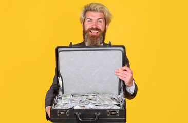 Smiling businessman with briefcase with money. Business man with suitcase full of dollars. Case with cash. Wealth and rich.