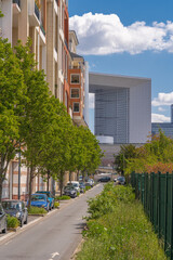 Obraz na płótnie Canvas Nanterre, France - 05 02 2021: La Defense district. View of Arch of La defense and modern buildings from an Avenue