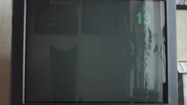 On screen, old, square, CRT TV, noise, does not catch channel, program. Close-up. In afternoon room