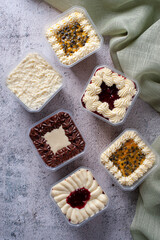 Variety of cake in the pot for delivery. Strawberry, passion fruit, chocolate and coconut flavor. Top view.