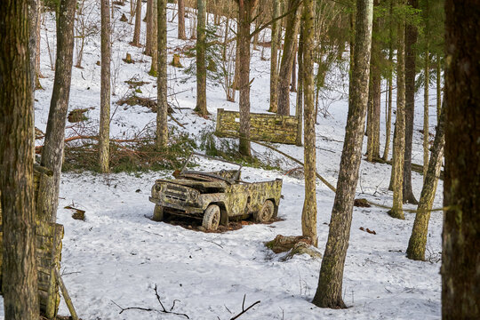 Old convertible Russian car in the paintball arena during winter time.