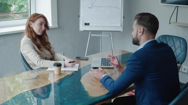 Businesswoman Interviewing Male Job Candidate In Meeting Room. Job HR applicants having an interview with Human resource manager jobs interviewing with confident candidate at business firm office.